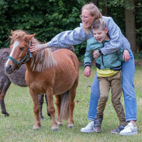 Mijke verpleegkundige met client Lars bij een paard